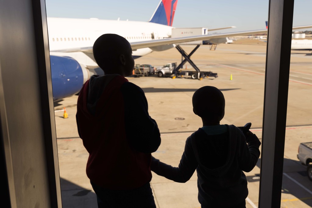 My boys waiting at the gate to board the plane.